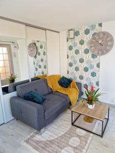 a living room with a couch and a table at Havre de Paix - Maisonnette Charmante avec Extérieur Privé in Blois