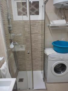 a shower in a bathroom with a washing machine at Iris in Benalmádena