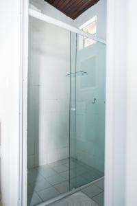 a glass shower door in a room with at Pousada Sette Mares in Fernando de Noronha