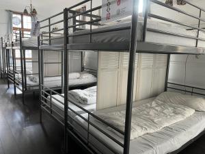 a group of bunk beds in a room at The Walrus Bar and Hostel in London