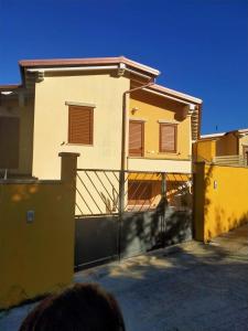 a house with a fence in front of it at CASA MIA in Solanas