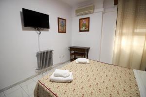 Postel nebo postele na pokoji v ubytování Hotel Virgen de los Reyes