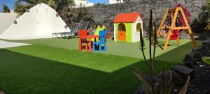 a playground with colorful chairs and a slide at Villa Sunset Faro Deluxe & Spa Pool in Playa Blanca
