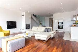 a living room with a white couch and a table at Villa Superior Two in Crikvenica