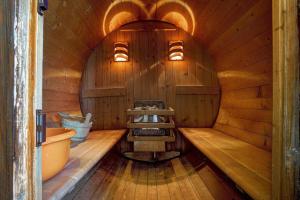 a wooden sauna with a tub and a sink at The Love Villa in Kassiopi