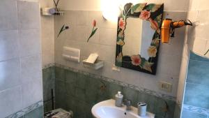 a bathroom with a sink and a mirror at CASA VACANZE ROSA BLU in Giffoni Valle Piana