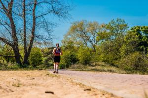 a woman running on a dirt road at Hotel Mare Liberum in Egmond aan Zee