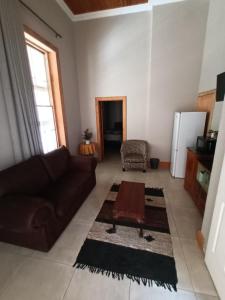 a living room with a couch and a table at Featherhouse in Colesberg