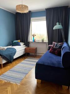 a bedroom with a bed and a couch and a window at Homestay in picturesque village 