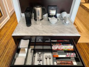 a counter top with a coffee maker and a coffeeettel at InterContinental Johannesburg OR Tambo Airport Hotel, an IHG Hotel in Kempton Park