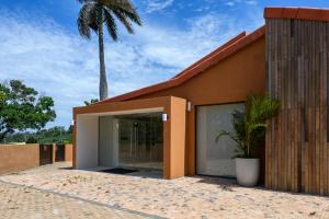 a building with a palm tree in front of it at San Lameer Villa 2832 - 3 Bedroom Classic - 6 pax - San Lameer Rental Agency in Southbroom