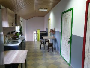 a kitchen with a sink and a table with chairs at Мандри Хостел in Uzhhorod