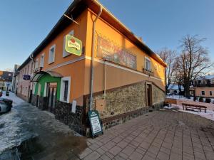 a building with a sign on the side of it at Penzión Velická vináreň in Poprad