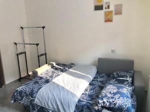 a bed with a blue and white comforter in a bedroom at Golubović Apartman in Crni Vrh