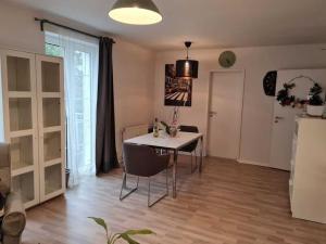 a dining room with a table and chairs and a refrigerator at gemütliche & ruhige Unterkunft in Erftstadt