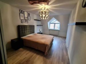um quarto com uma cama grande e um lustre em gemütliche & ruhige Unterkunft em Erftstadt