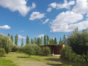 ein Haus inmitten eines Feldes mit Bäumen in der Unterkunft Finca La Calma in San Rafael