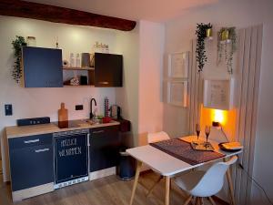 a small kitchen with a table and a table and chairs at Apartment three Rivers2 in Passau