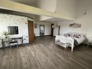 a large room with a bed and a television at The Crown Lodges in Deal