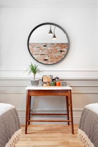 a mirror on a wall next to a table at World House Boutique Hotel Galata in Istanbul