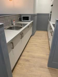 an empty kitchen with a sink and a microwave at DS Study or Visit in Dundee