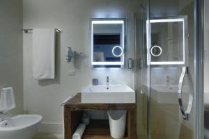 La salle de bains est pourvue d'un lavabo et d'une douche en verre. dans l'établissement Hotel Antica Abbazia, à Borso del Grappa