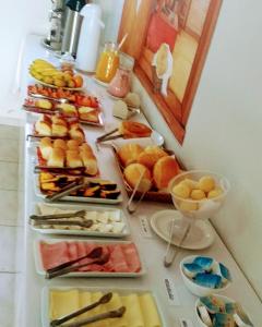 a table with many different types of food on it at Hotel Guarini in Monte Sião