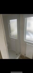a bathroom with a shower and a window at Seaside chill in Prestatyn