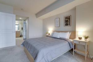 a bedroom with a large bed and two night stands at Stunning Apt with Gym at Pentagon City in Arlington