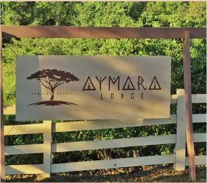 een bord voor een Amazone lodge aan een hek bij Aymara Lodge in Poconé