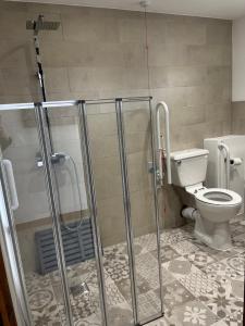 a bathroom with a shower and a toilet at The Crown Lodges in Deal