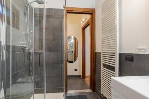 a bathroom with a glass shower and a sink at Cernobbio Charming APT! in Cernobbio +9 photos