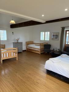 a large bedroom with two beds and a desk at The Crown Lodges in Deal