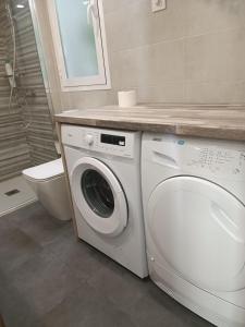 baño con aseo y lavadora blanca en Apartamento Retiro, en Madrid