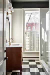 a bathroom with a sink and a window at Blind Tiger Portland - Carleton Street in Portland