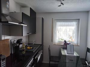 a kitchen with a counter top and a window at Ferienhaus Hermann in Schönwald