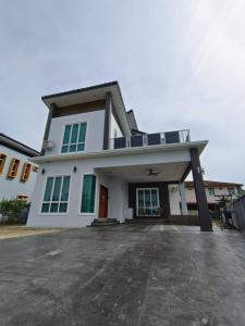 a large white house with a lot of windows at LUXURY Modern House Kubang Kerian UNIFI 4 Bedrooms in Kota Bharu