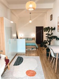 a living room with a bed and a table at Shelter by the hill 104 in Ho Chi Minh City