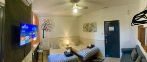 Habitación con 2 camas y TV de pantalla plana. en Itinere Rooms, en Granada