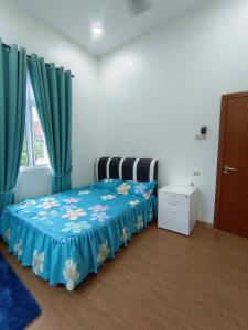 a bedroom with a bed with a blue blanket and curtains at LUXURY Modern House Kubang Kerian UNIFI 4 Bedrooms in Kota Bharu