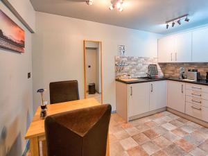 a kitchen and dining room with a table and chairs at Vyrnwy Lakeside - Bala Lake in Bala