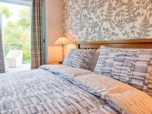 a bedroom with a bed and a window at Vyrnwy Lakeside - Bala Lake in Bala