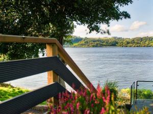 a wooden staircase with a view of a lake at Vyrnwy Lakeside - Bala Lake in Bala