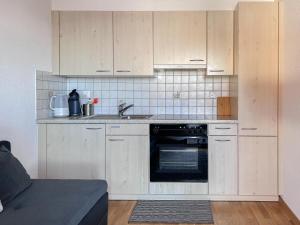 a kitchen with white cabinets and a sink at Chalet Dennda Nr 27 in Rosswald
