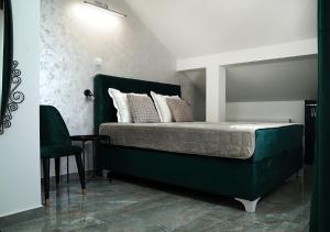 a bedroom with a green bed with a mirror at Aster Apartments in Belgrade