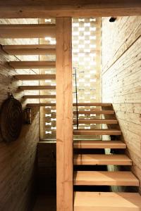 a wooden staircase in a room with a brick wall at Stefan Glowacz CHALET mit traumhaftem Bergblick in Grainau +66 photos