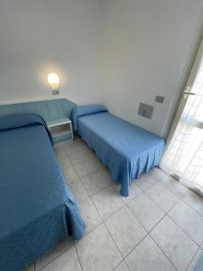 Postel nebo postele na pokoji v ubytování Albergo Désirée