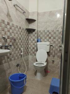 a bathroom with a toilet and a sink at Budha ashram guest house in Bodh Gaya