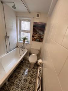 a bathroom with a toilet and a tub and a sink at Berry View - Idyllic cosy cottage on berry farm in Blairgowrie