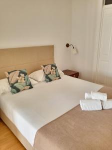 una camera con due grandi letti con cuscini di Alfama Apartments Services a Lisbona